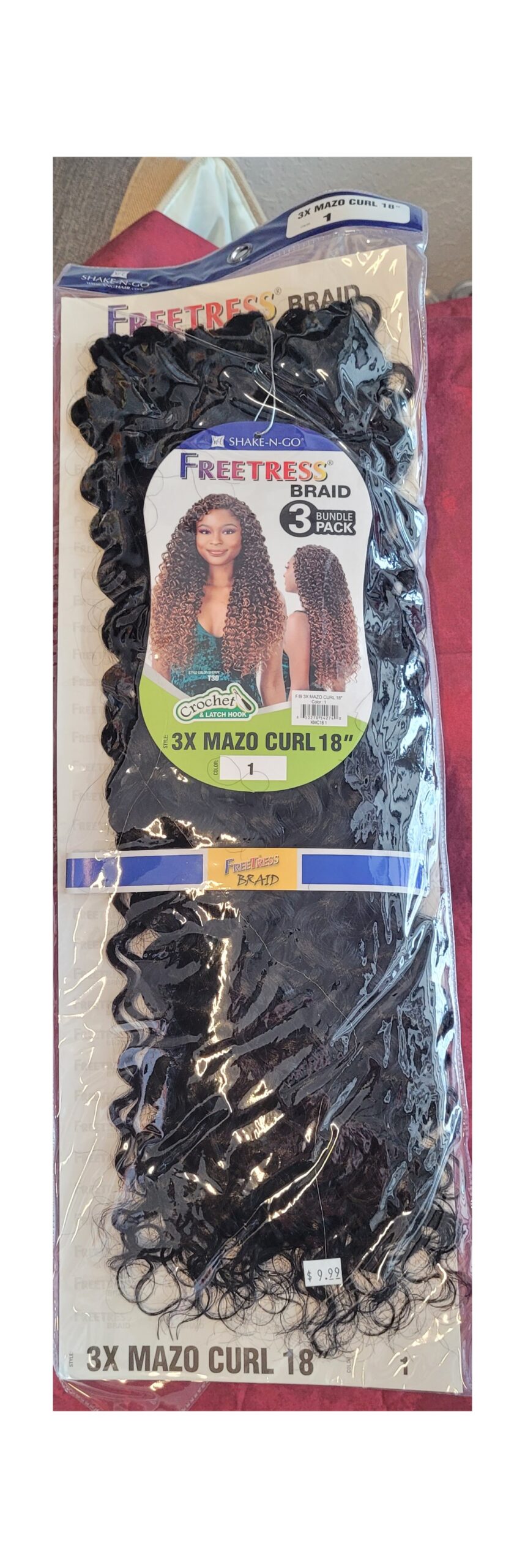 black curly wig in its packaging